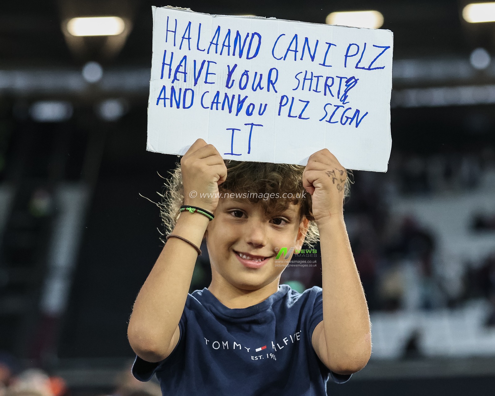 A young Manchester City fan with a sign asking for Erling Haaland of Manchester City shirt during the Premier League match West Ham United vs Manchester City at London Stadium, London, United Kingdom, 31st August 2024

(Photo by Mark Cosgrove/News Images)