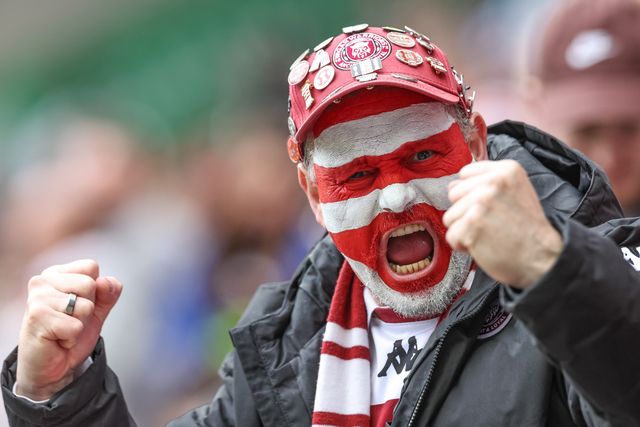A Wigan fans with his face painted in cherry and white celebrates the try of Abbas Miski of Wigan Warriors during the Betfred Super League Round 8 match Wigan Warriors vs St Helens at The Brick Community Stadium, Wigan, United Kingdom, 18th April 2025

(Photo by Mark Cosgrove/News Images)