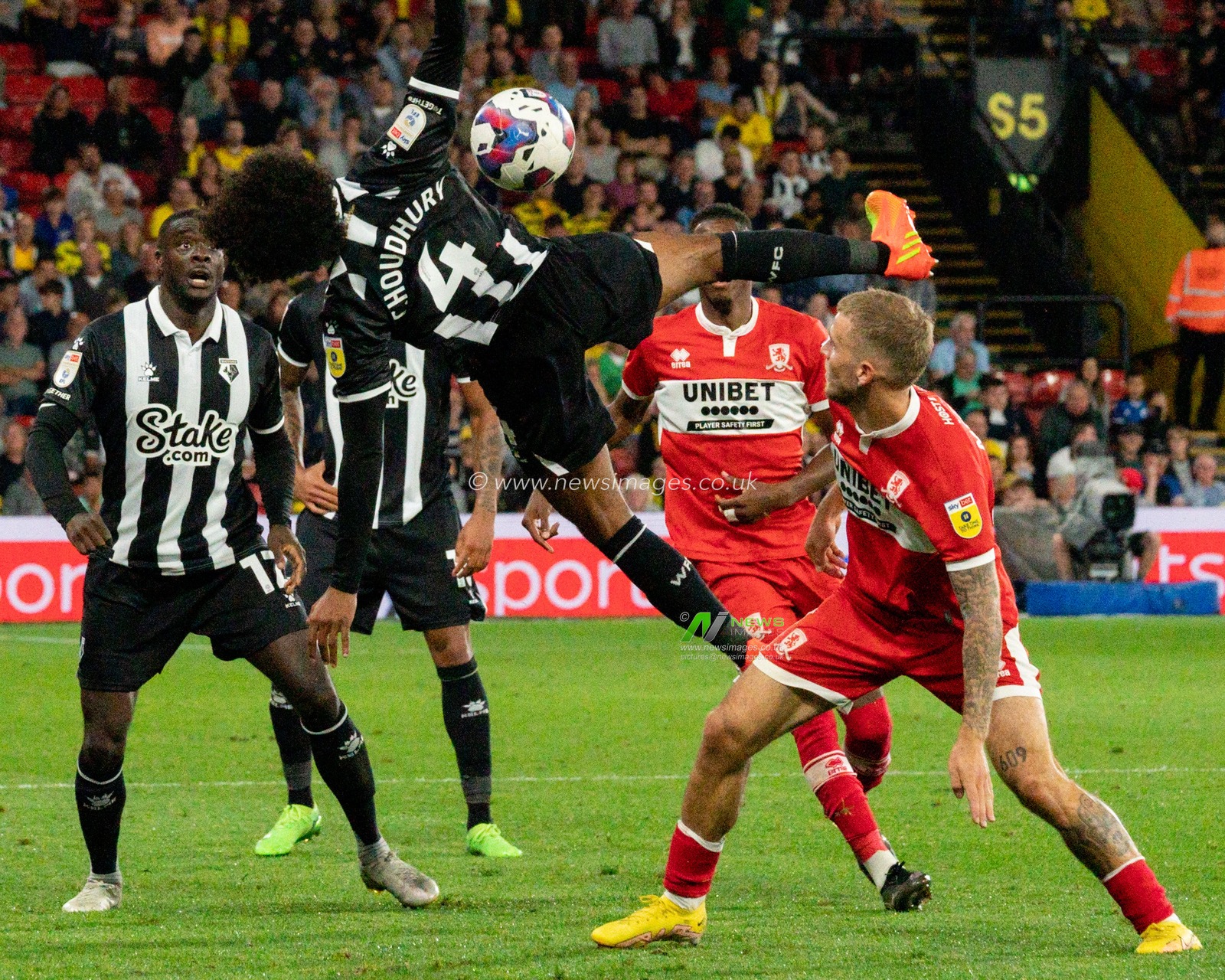 Hamza Choudhury #4 of Watford battle for the ball with Riley McGree #8 of Middlesbrough