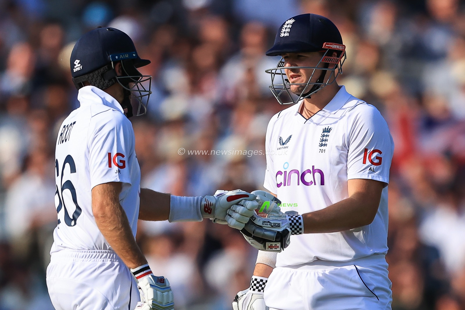 Joe Root of England and Alex Lees bump fists between overs