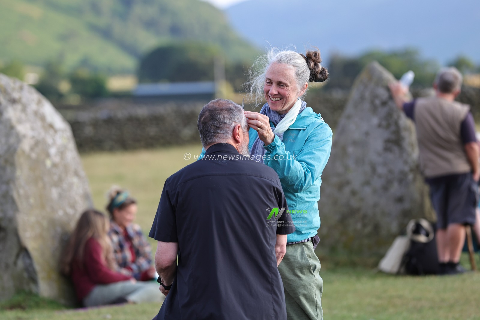 A person has their hair cut by their partner during the Castlerigg Stone Circle Summer Solstice Celebration. It's believed Castlerigg Stone Circle was constructed around 3200 BC, and although its original purpose remains largely unknown, possible uses include a trading post, meeting place, a religious site or an astronomical observatory.Castlerigg Stone Circle, Keswick, United Kingdom, 20th June 2023

(Photo by Alfie Cosgrove/News Images)