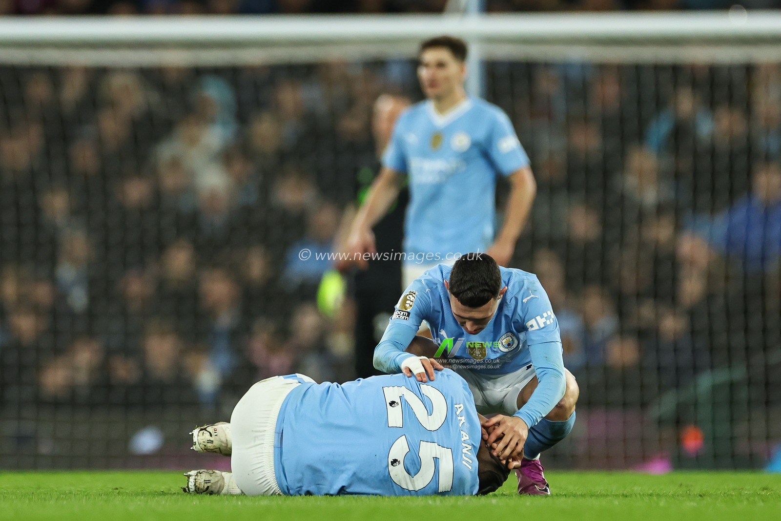 Phil Foden of Manchester City checks on Manuel Akanji of Manchester City as he lies injured during the Premier League match Manchester City vs Aston Villa at Etihad Stadium, Manchester, United Kingdom, 3rd April 2024

(Photo by Mark Cosgrove/News Images)