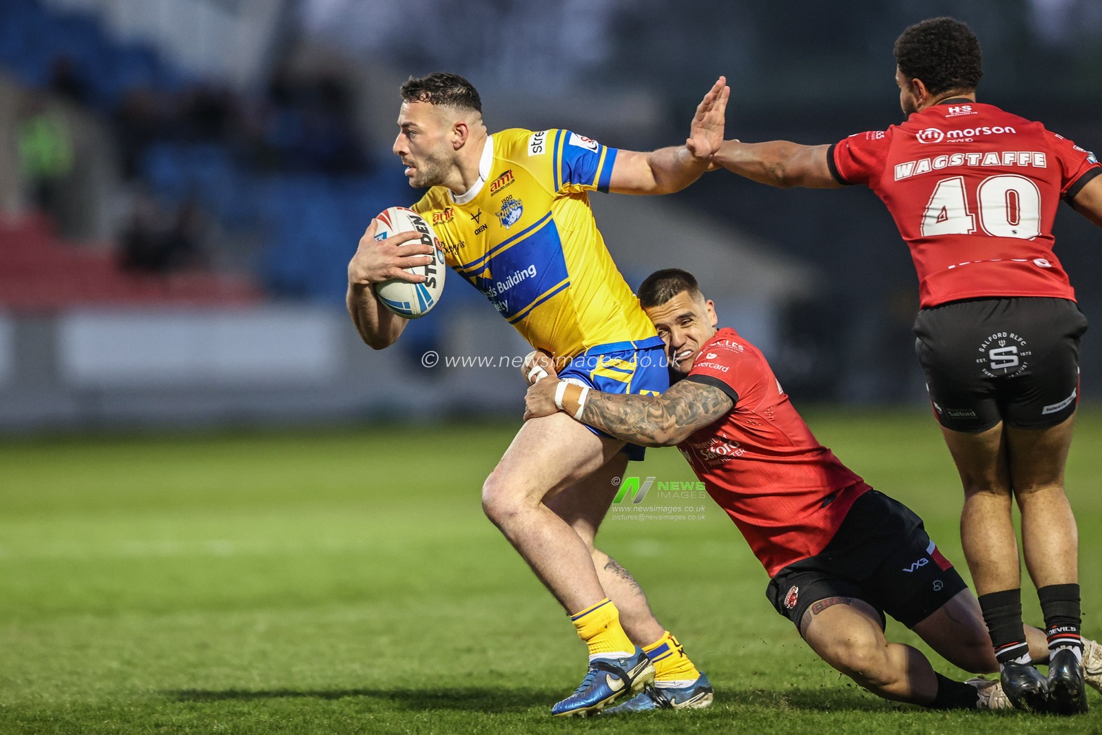 Jake Connor of Leeds Rhinos is tackled by Jayden Nikorima of Salford Red Devils during the Betfred Super League match Salford Red Devils vs Leeds Rhinos at Salford Community Stadium, Eccles, United Kingdom, 10th April 2025

(Photo by Alfie Cosgrove/News Images)