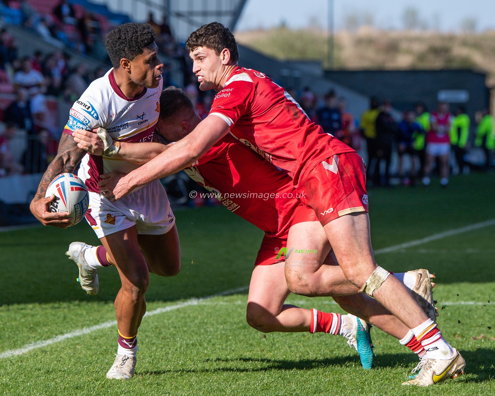 Kevin Naiqama #4 of Huddersfield Giants is tackled by Matt Costello #24 and Sam Stone #12 of Salford Red Devils  during the Betfred Super League Round 7 match Salford Red Devils vs Huddersfield Giants at AJ Bell Stadium, Eccles, United Kingdom, 2nd April 2023

(Photo by Craig Thomas/News Images)