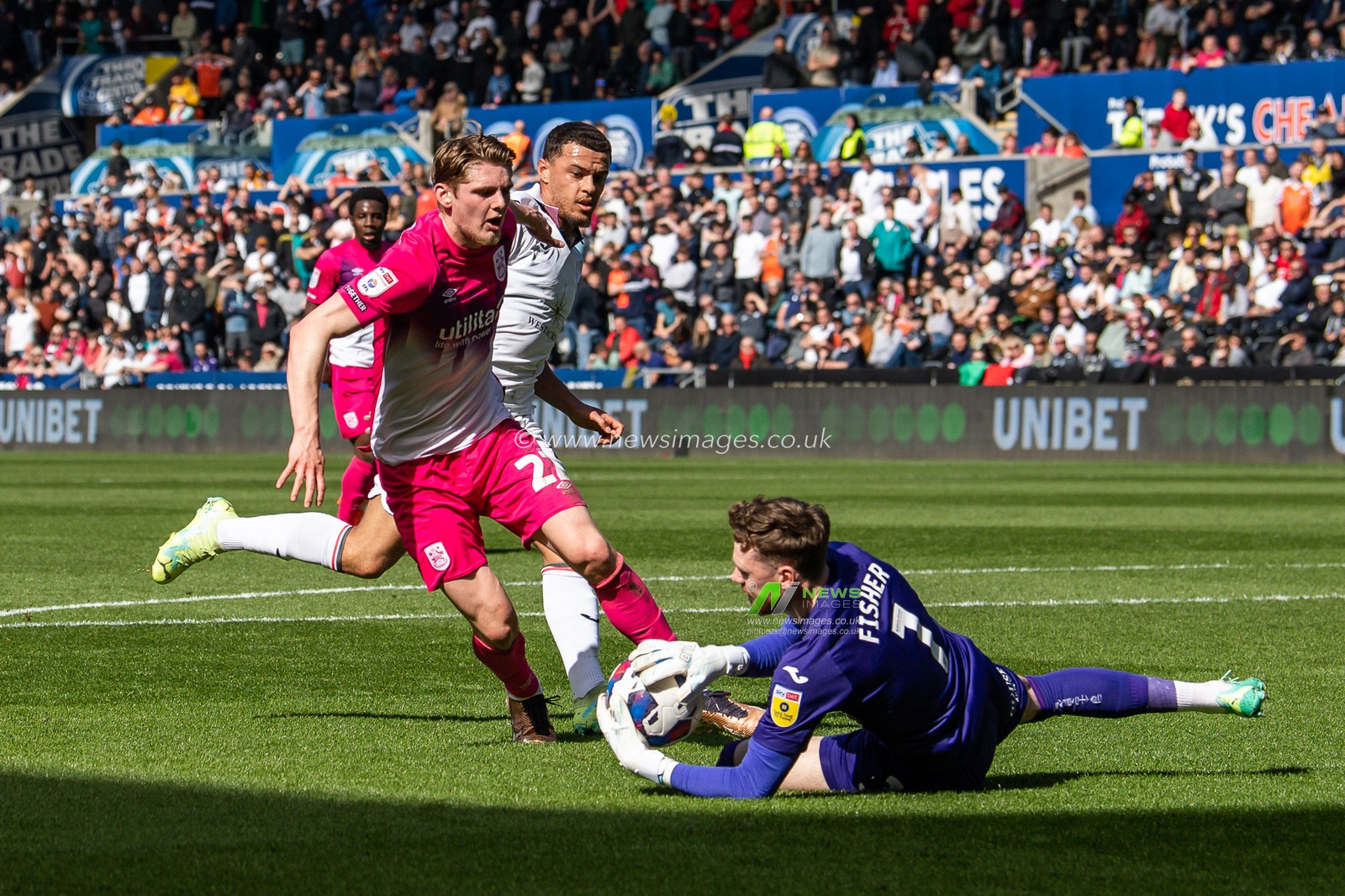 Andy Fisher #1 of Swansea City saves at the feet of Jack Rudoni #22 of Huddersfield Town during the Sky Bet Championship match Swansea City vs Huddersfield Town at Swansea.com Stadium, Swansea, United Kingdom, 15th April 2023

(Photo by Craig Thomas/News Images)