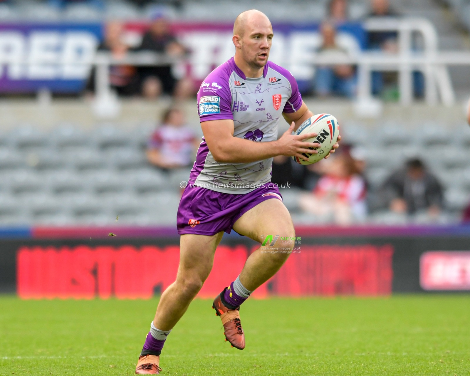 George King (16) of Hull KR runs forward with the ball