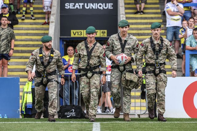 The British Marines deliver the match ball during the Betfred Super League round 15 match Warrington Wolves vs Huddersfield Giants at Halliwell Jones Stadium, Warrington, United Kingdom, 21st June 2025

(Photo by Alfie Cosgrove/News Images)
